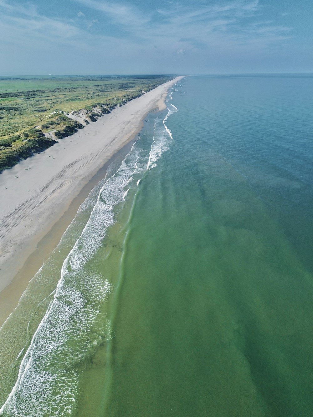 an aerial view of a beach and a body of water