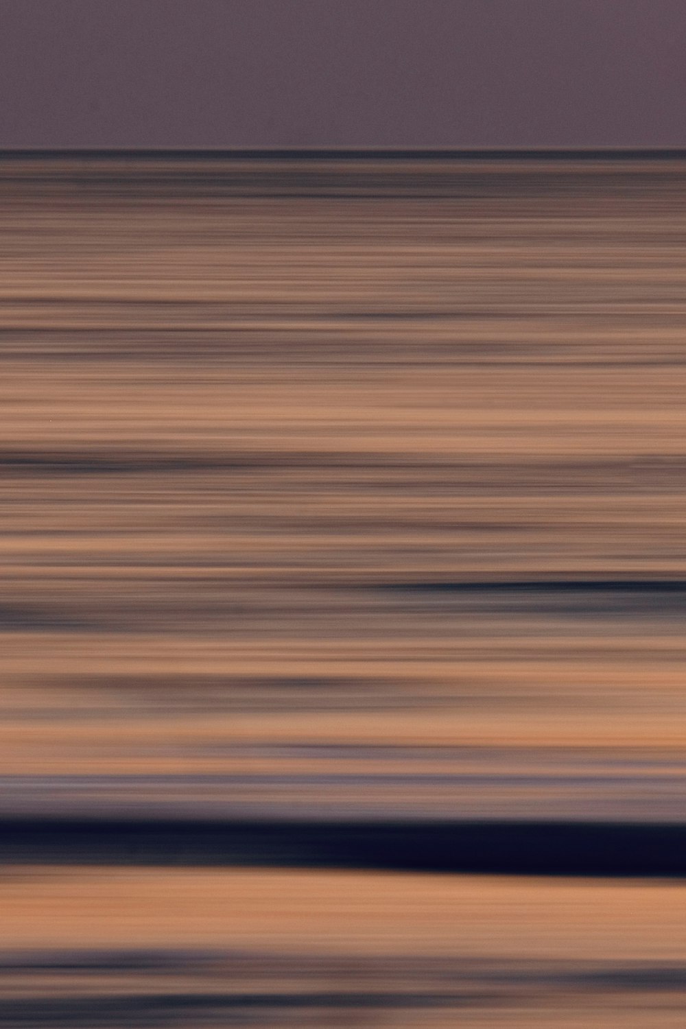 a blurry photo of a bird flying over the ocean