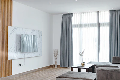 Modern living room with automated curtains opening via remote control.