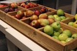 Close-up of fresh assorted fruits arranged in a wooden crate.