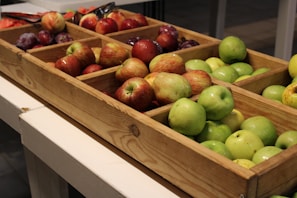 Close-up of fresh assorted fruits arranged in a wooden crate.