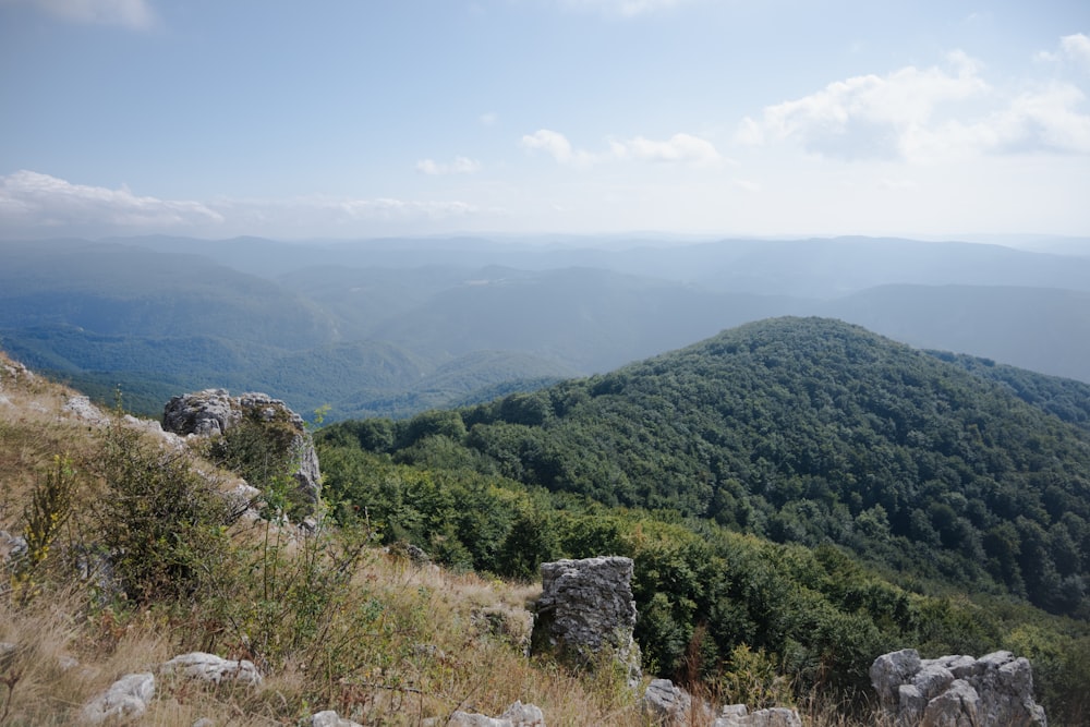 a view of the mountains from a high hill