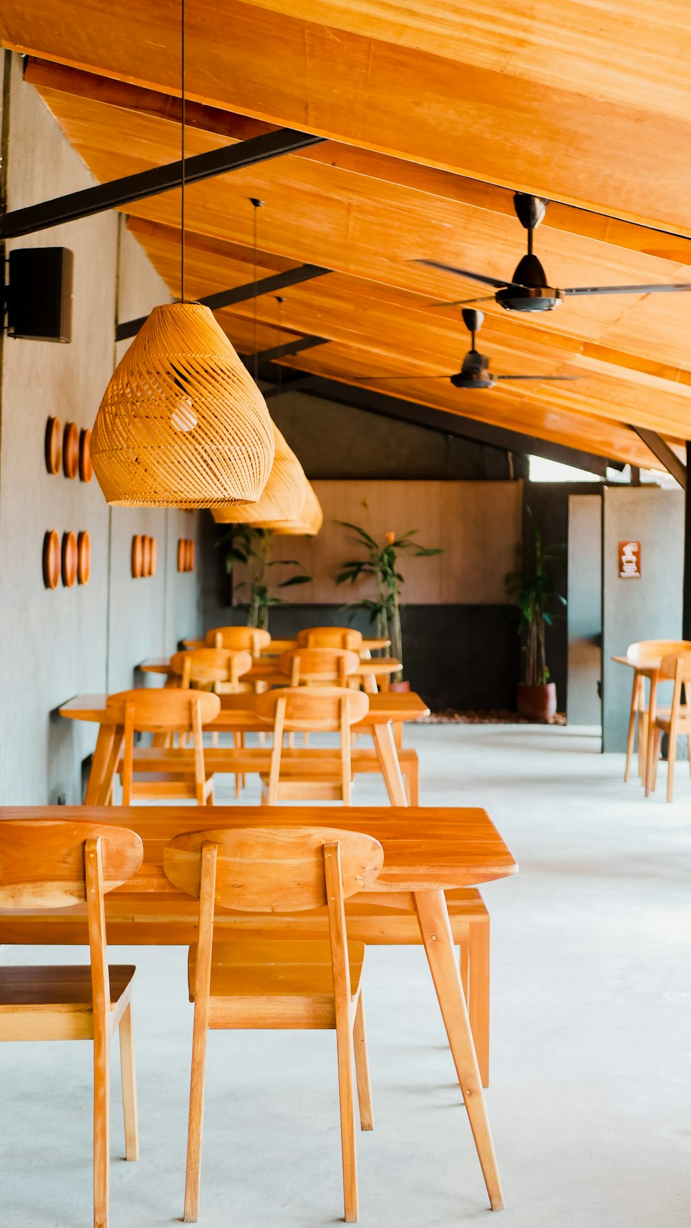 a restaurant with wooden tables and wooden chairs