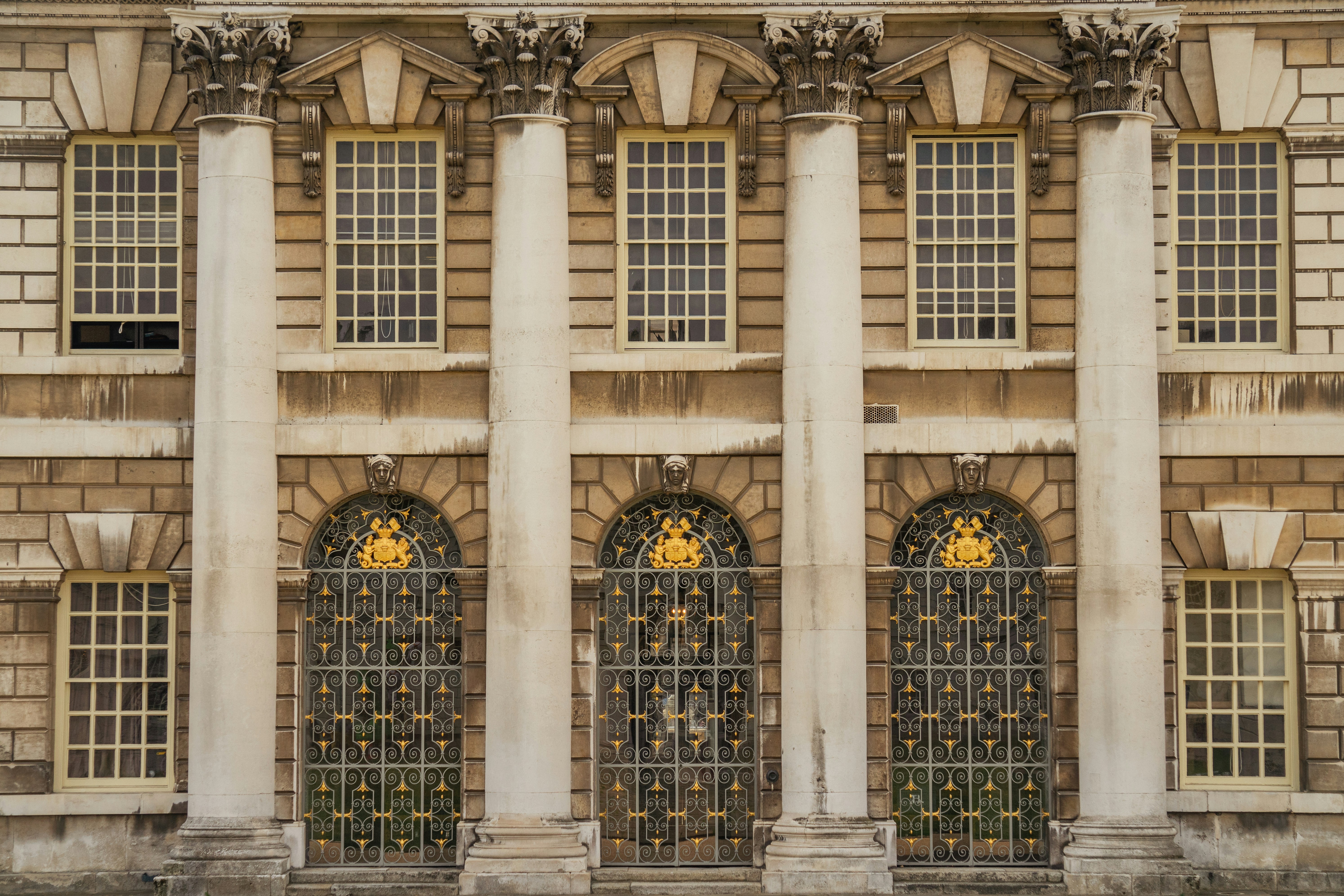 A large building with four windows and a clock on the front of it photo ...