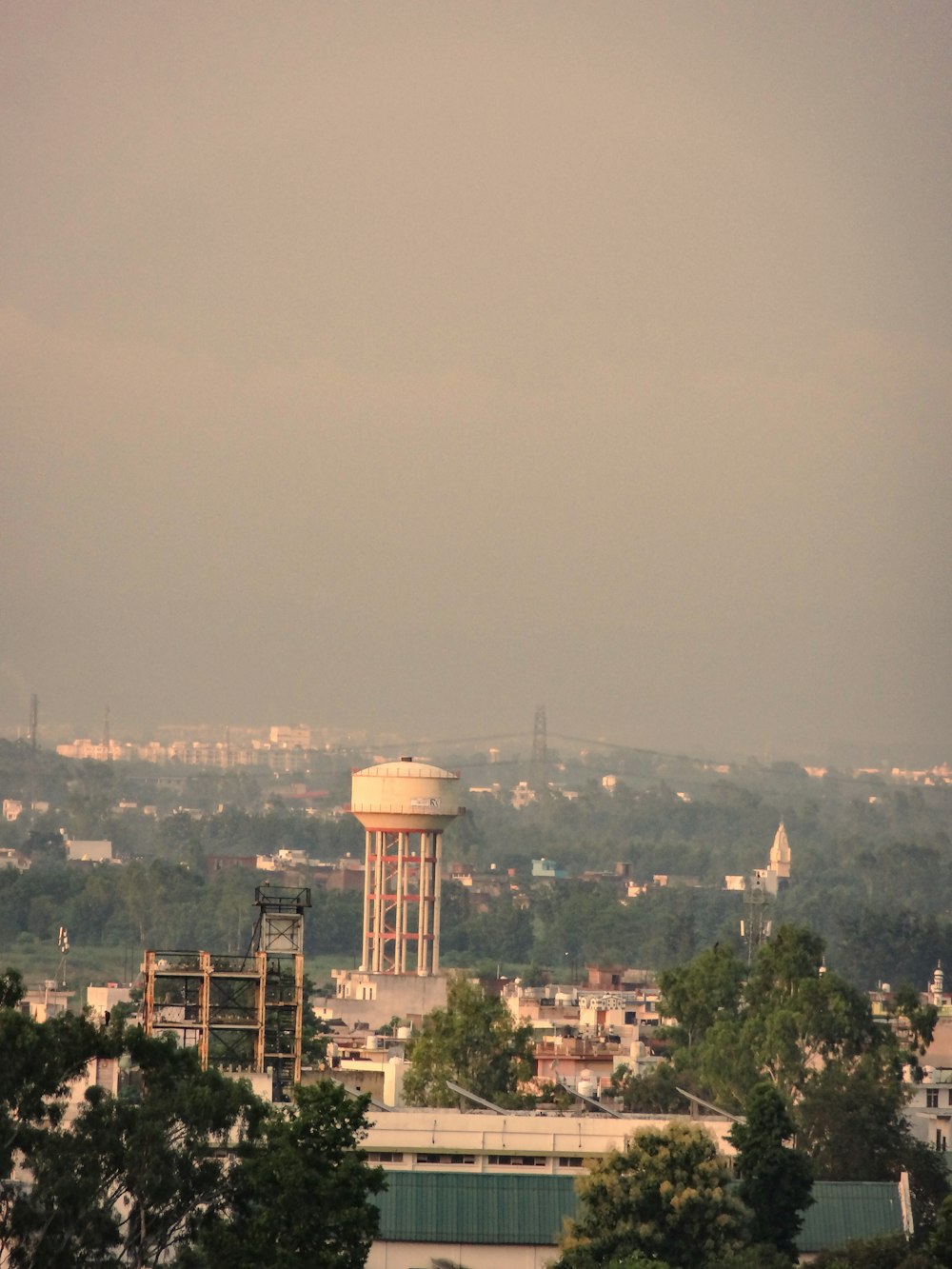 a view of a city with a water tower in the distance