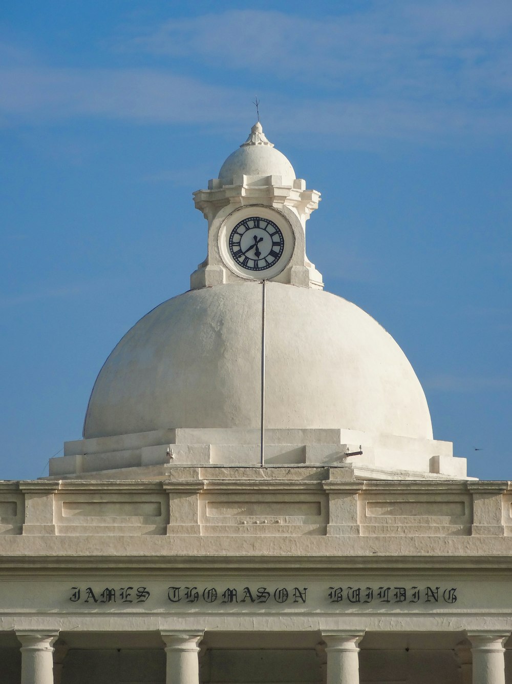 a large white dome with a clock on top