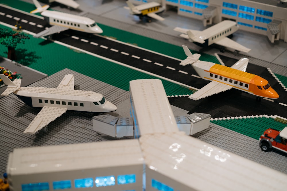 a lego model of an airport with airplanes and cars