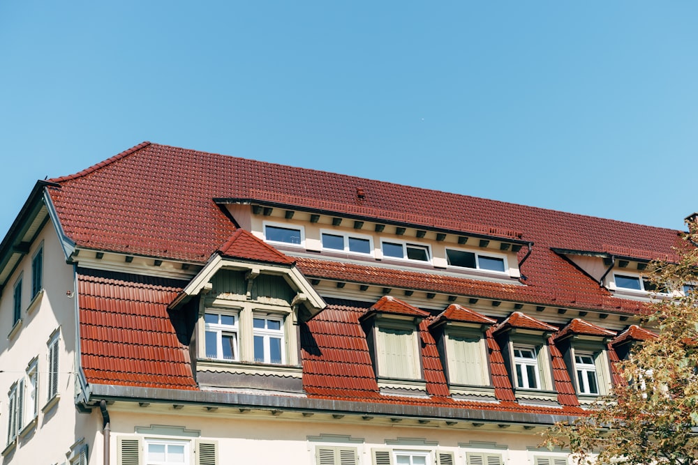 a house with a red roof and white windows