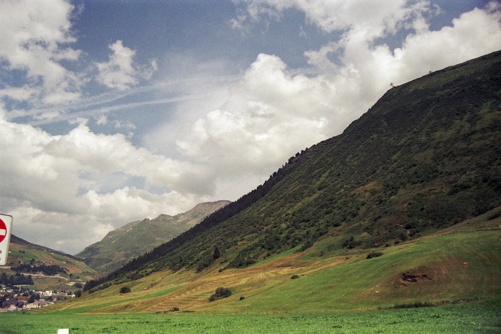 a stop sign in the middle of a lush green valley