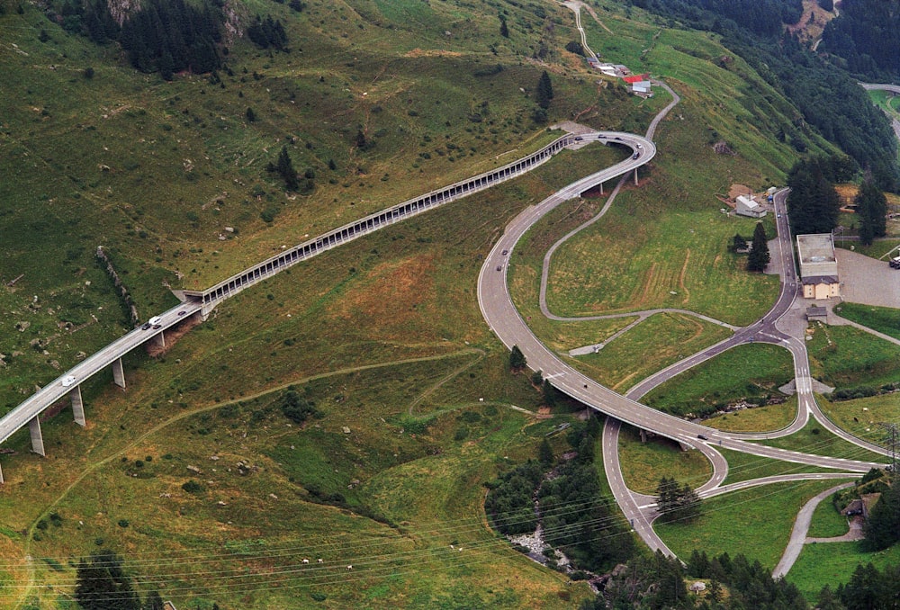 an aerial view of a winding road in the mountains