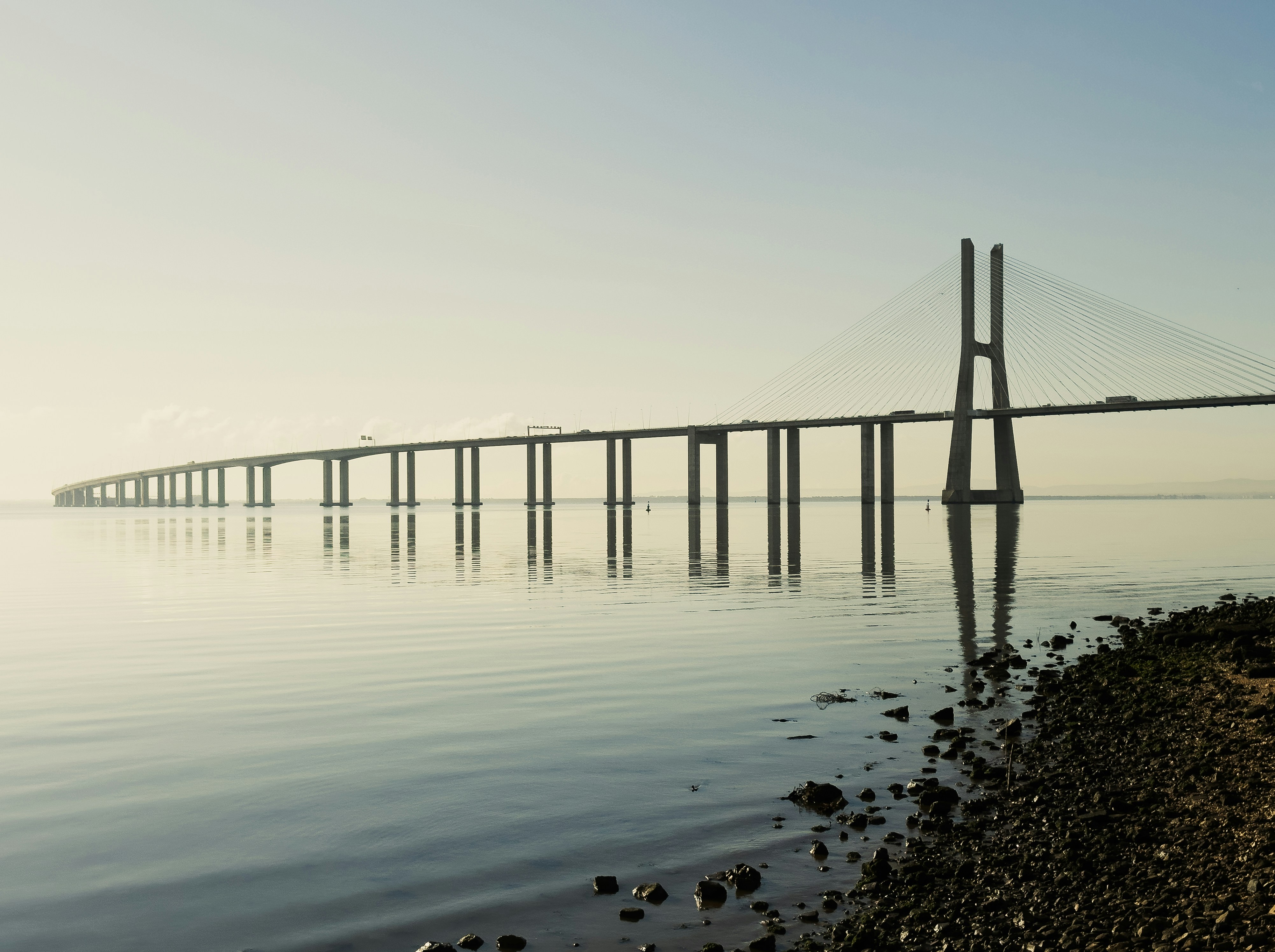 a long bridge spanning over a body of water, Vasco da Gama Bridge in Lisbon