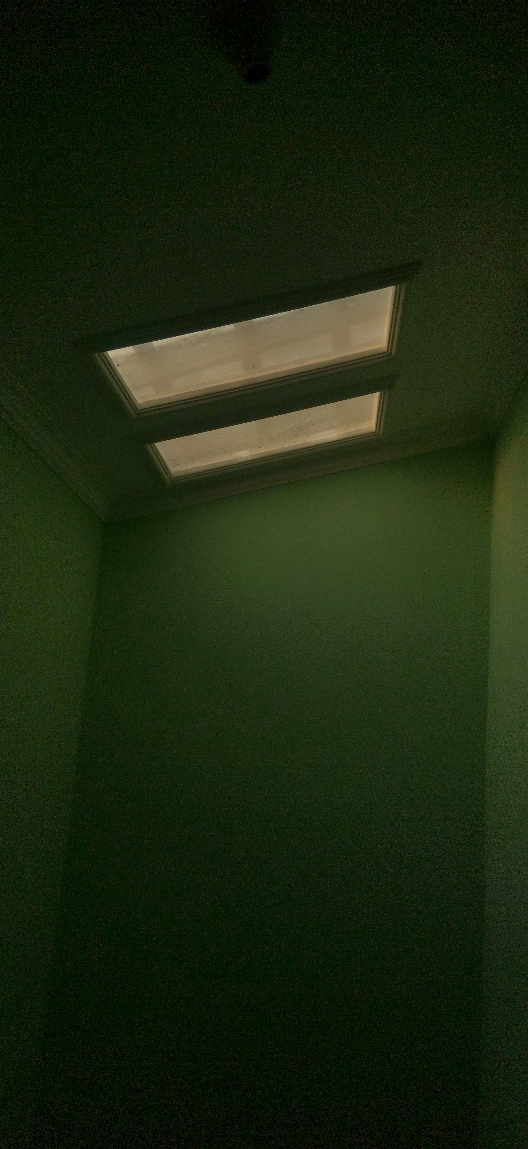 an empty room with a skylight in it
