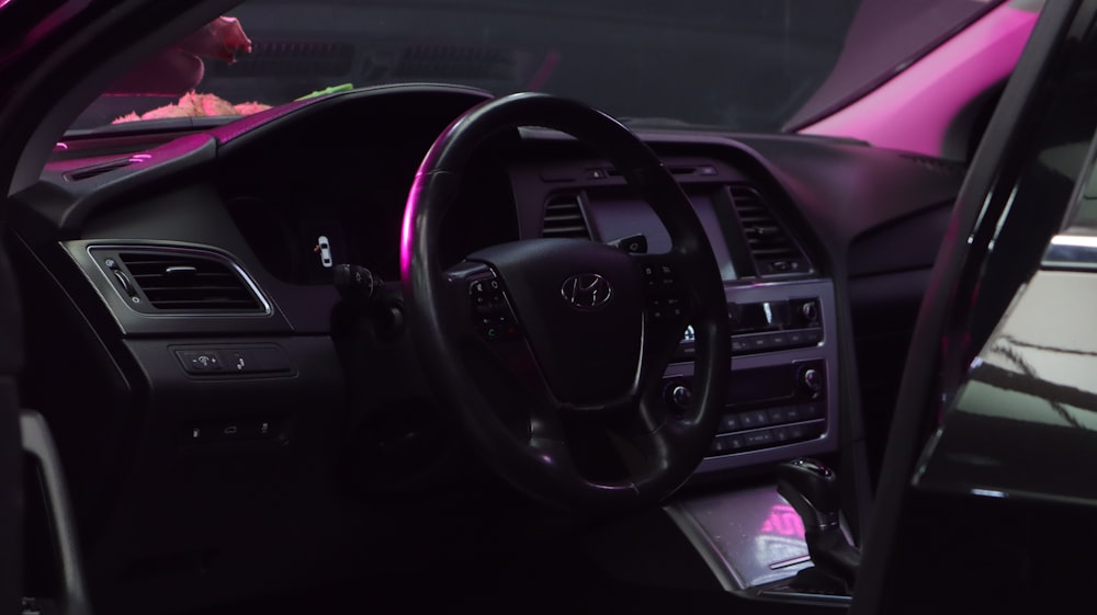 the interior of a car with a pink dash light