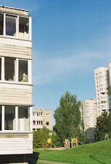 A friendly real estate agent showing a family a cozy apartment in a sunny neighborhood.