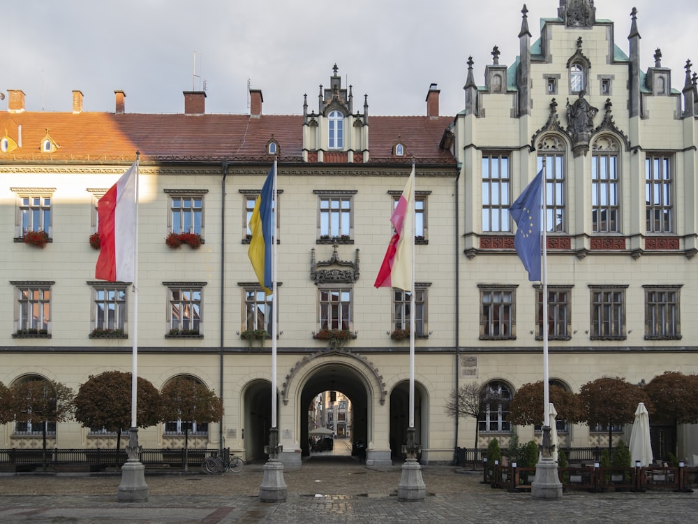 a large building with flags flying in front of it