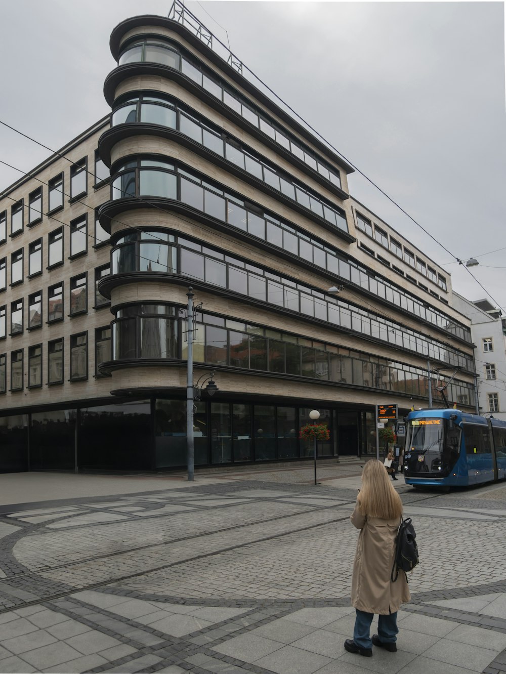 a woman standing in front of a large building