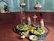 A serene brass Hanuman murti placed on a wooden shelf surrounded by marigold flowers.