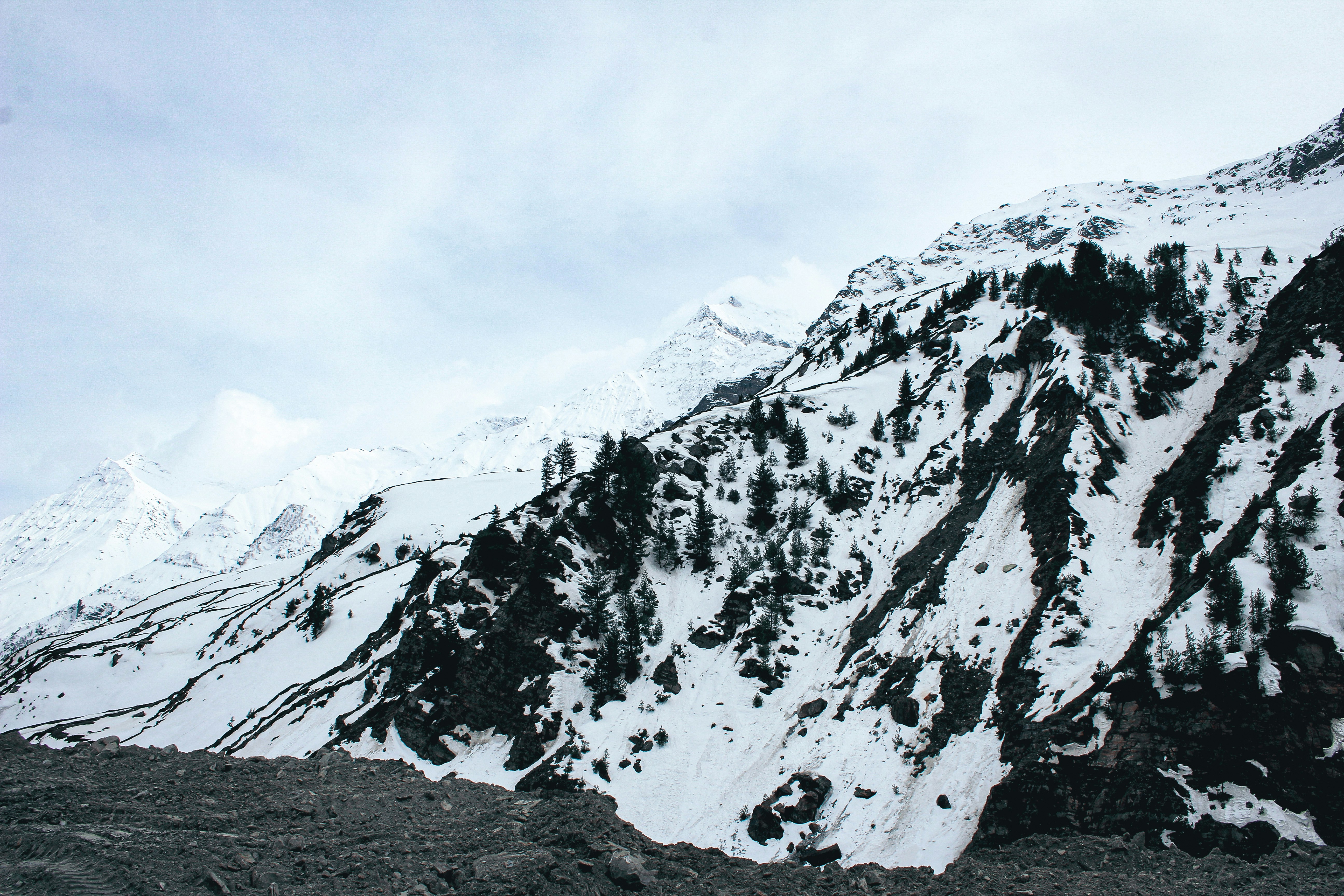a mountain covered in snow with a sky background