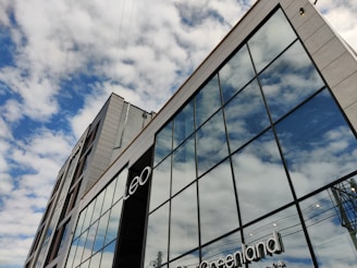 A modern building exterior with large glass windows.