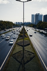 a street filled with lots of traffic next to tall buildings