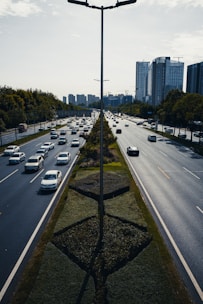 a street filled with lots of traffic next to tall buildings
