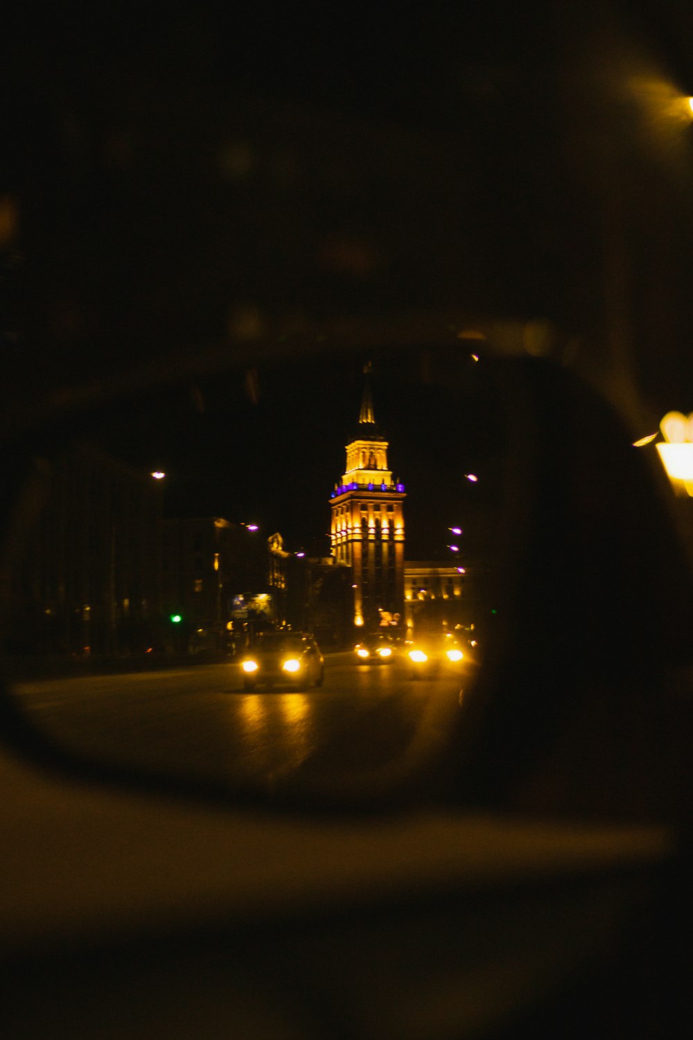 a view of a building through a rear view mirror