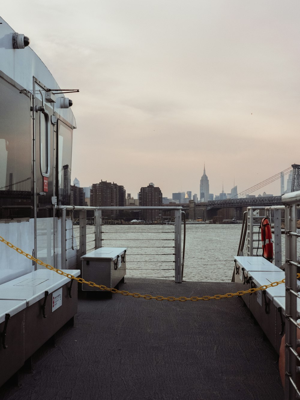 a couple of benches sitting on the side of a boat