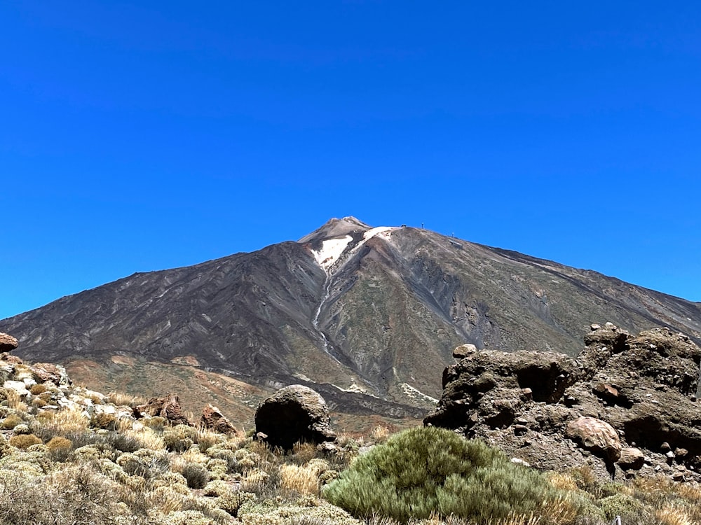 a mountain with a snow capped peak in the distance