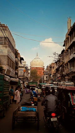 A bustling street scene in Bihar showing everyday life with people, markets, and local architecture.