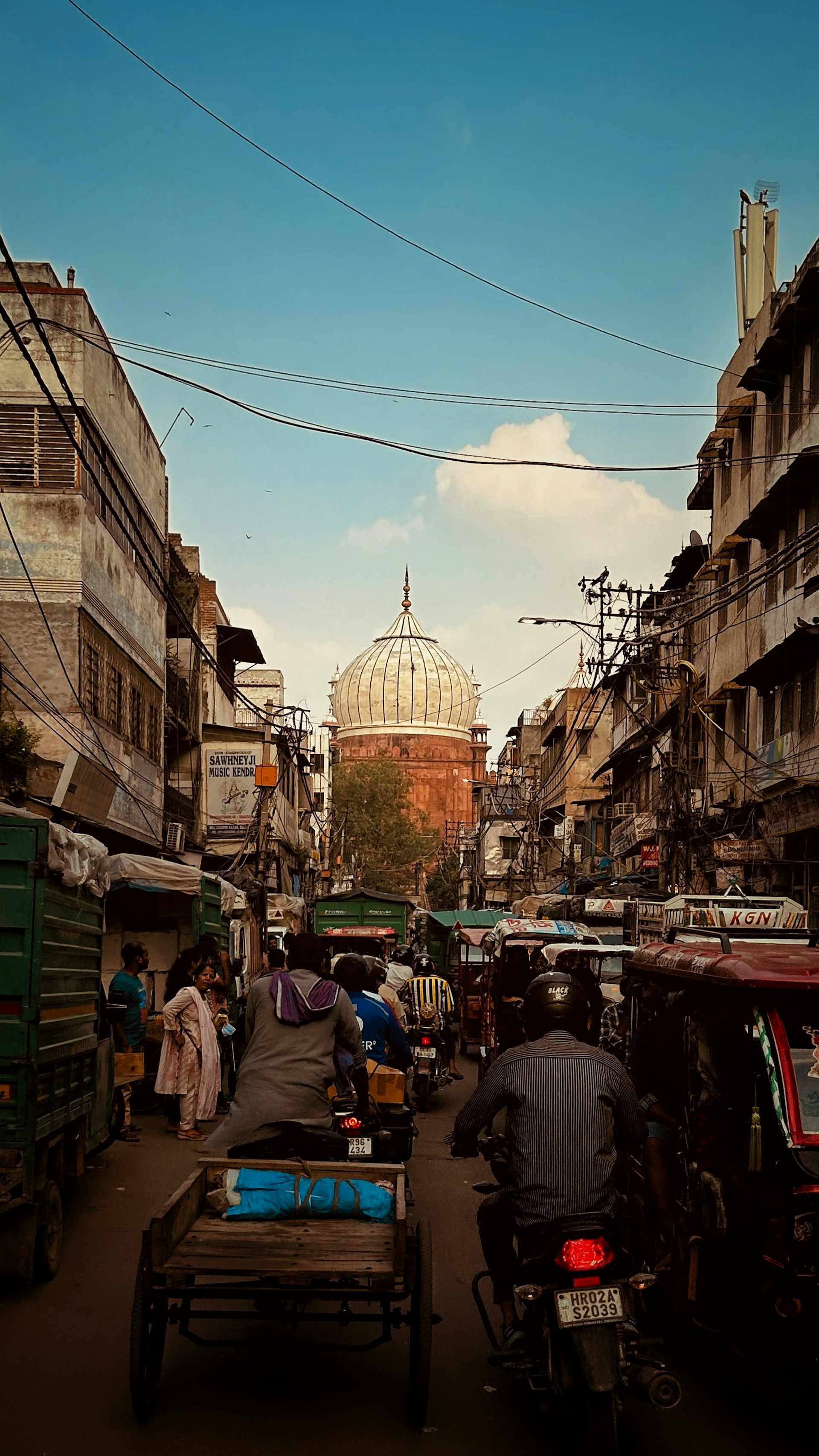 woman wearing yellow long-sleeved dress under white clouds and blue sky during daytime
