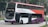 A double-decker bus with a red, white, and purple color scheme featuring the logo 'SBS Transit' on the side. The destination sign on the front of the bus displays route number 513. The bus is parked on a city street with greenery and buildings visible in the background.