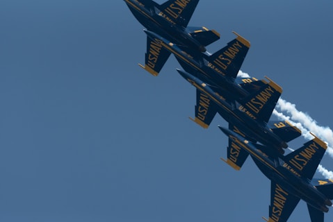 a formation of fighter jets flying through a blue sky
