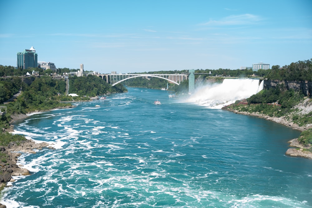 a view of a river with a bridge in the background