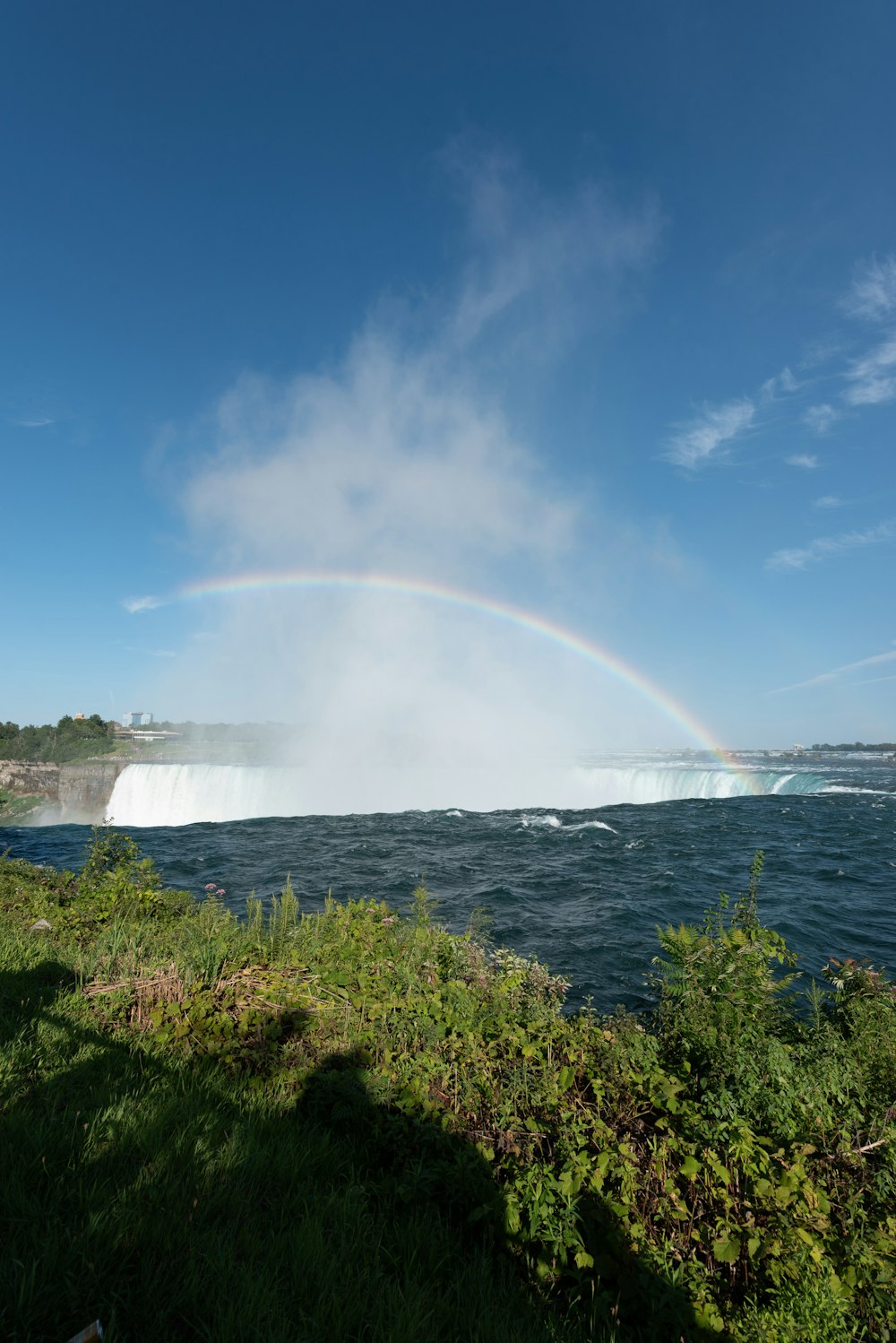 a rainbow in the sky over a body of water