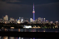 A nighttime cityscape with radio signals illustrated connecting people across the globe.
