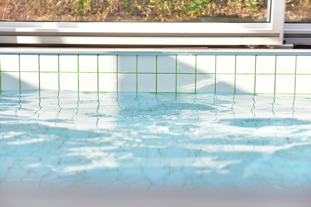 a pool of water with a window in the background