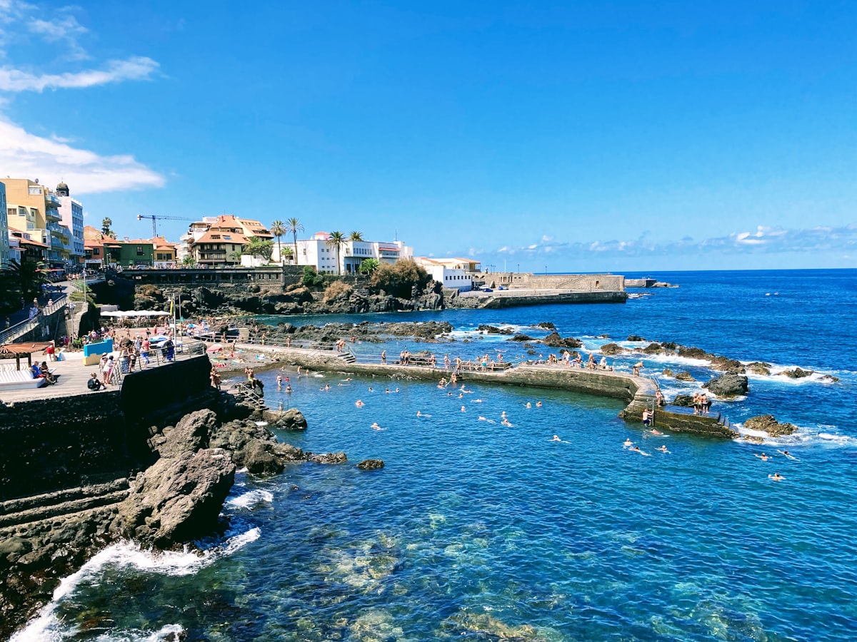 Tenerife August — crowded south coast bay at peak summer