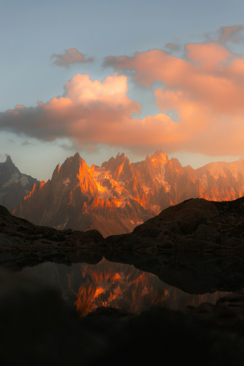 a mountain range with a body of water in the foreground