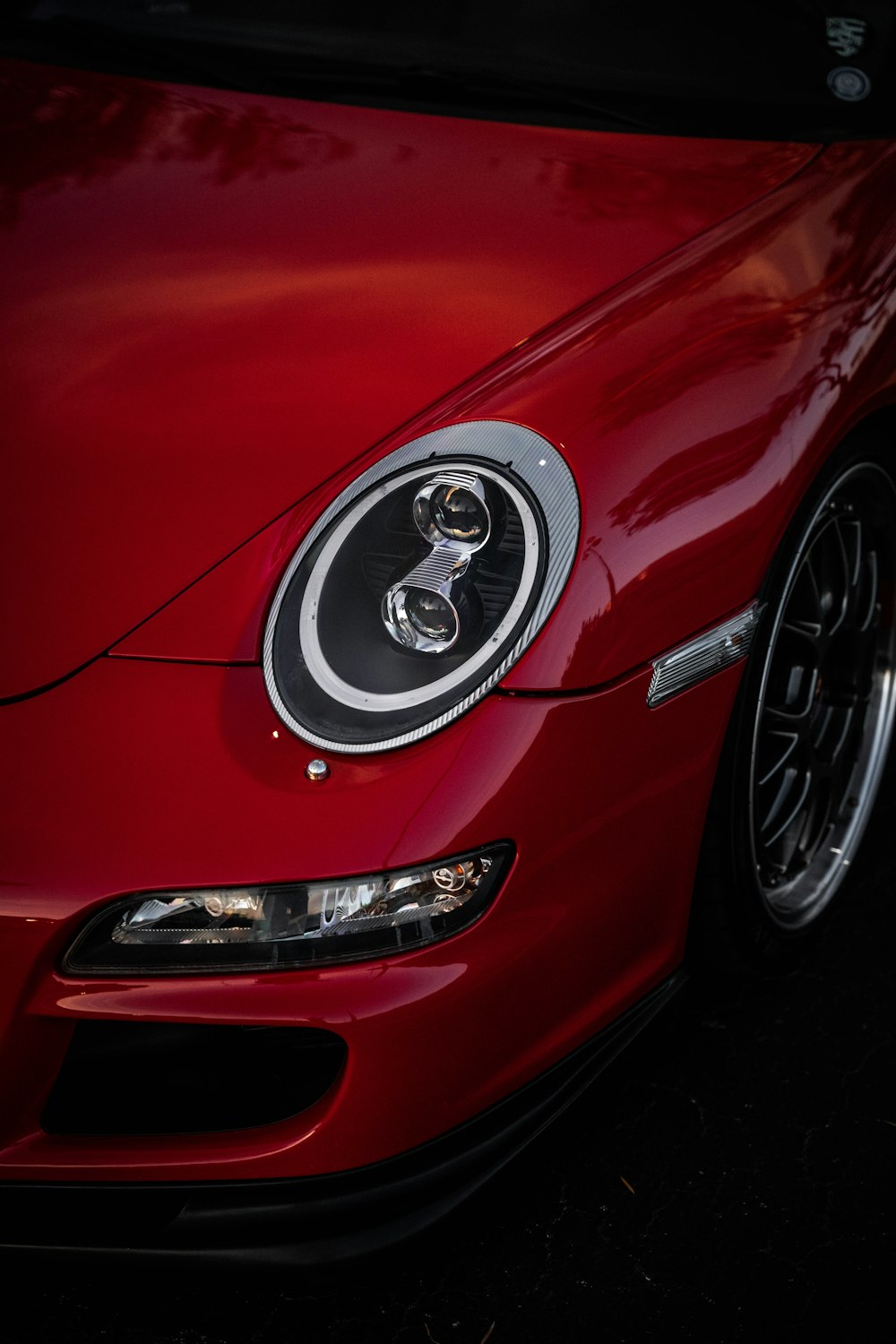 a close up of the front of a red sports car