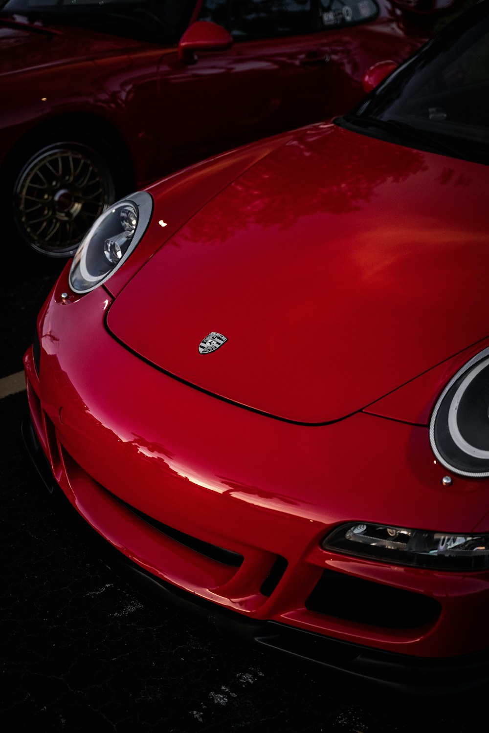 a red sports car parked in a parking lot