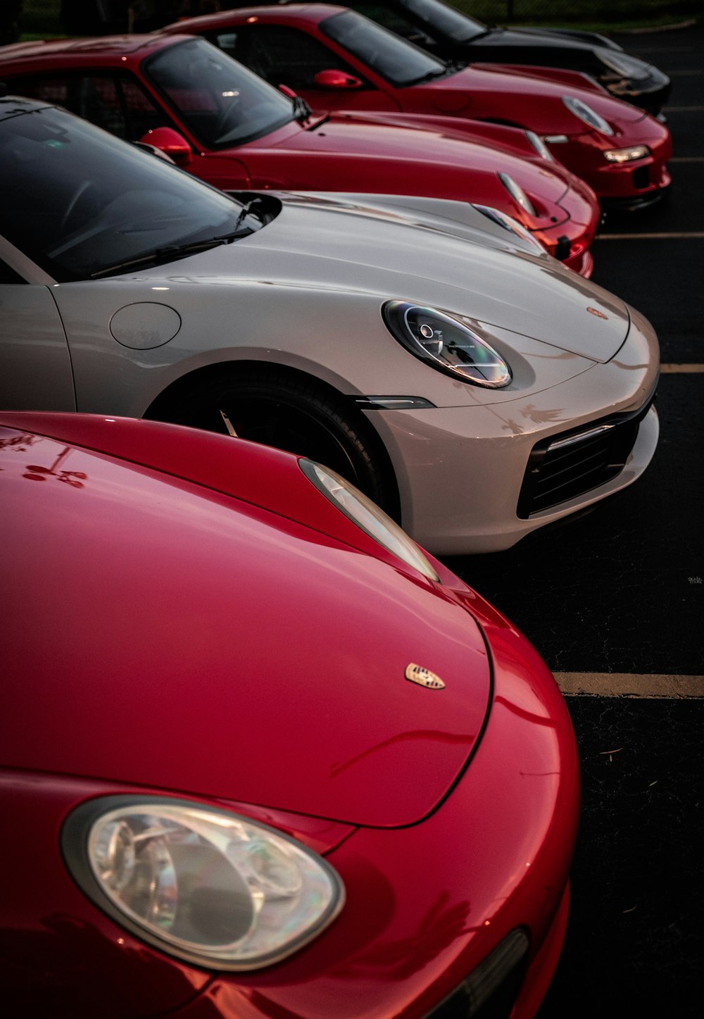 a row of parked cars in a parking lot