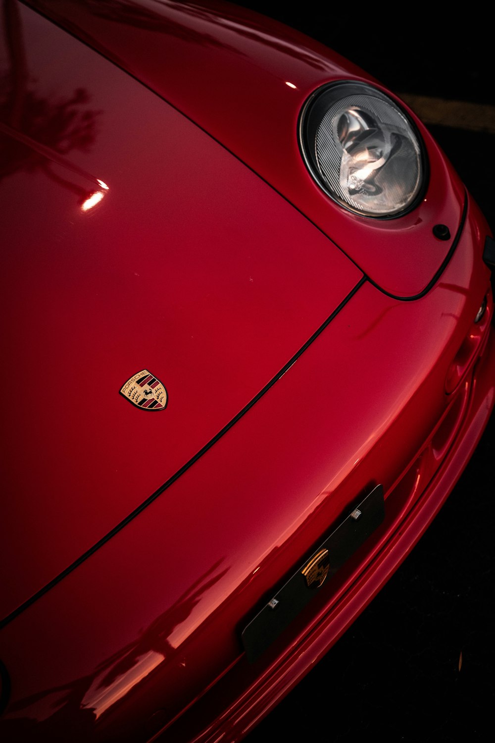 a close up of the front of a red sports car