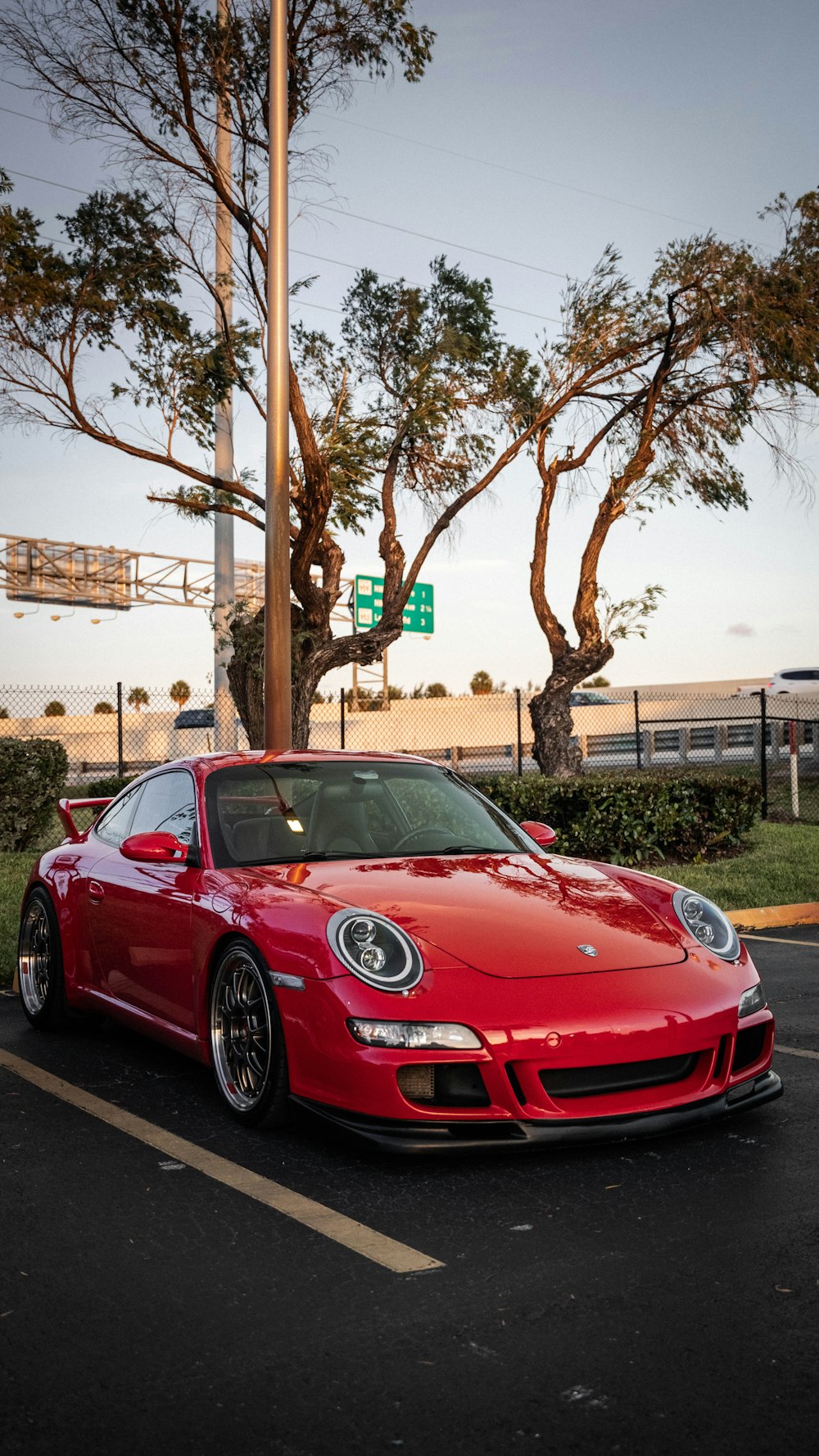 a red sports car parked in a parking lot