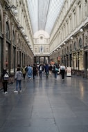a group of people walking down a long hallway
