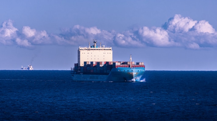 a large cargo ship in the middle of the ocean