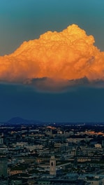 A glowing cloud icon hovering above a cityscape representing cloud technology.