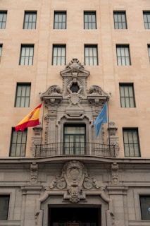 Renovated government building facade with fresh paint and repaired stonework.