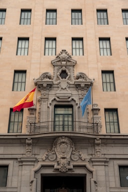 Renovated government building facade with fresh paint and repaired stonework.