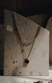 A model showcasing a stunning gold pendant in natural light.