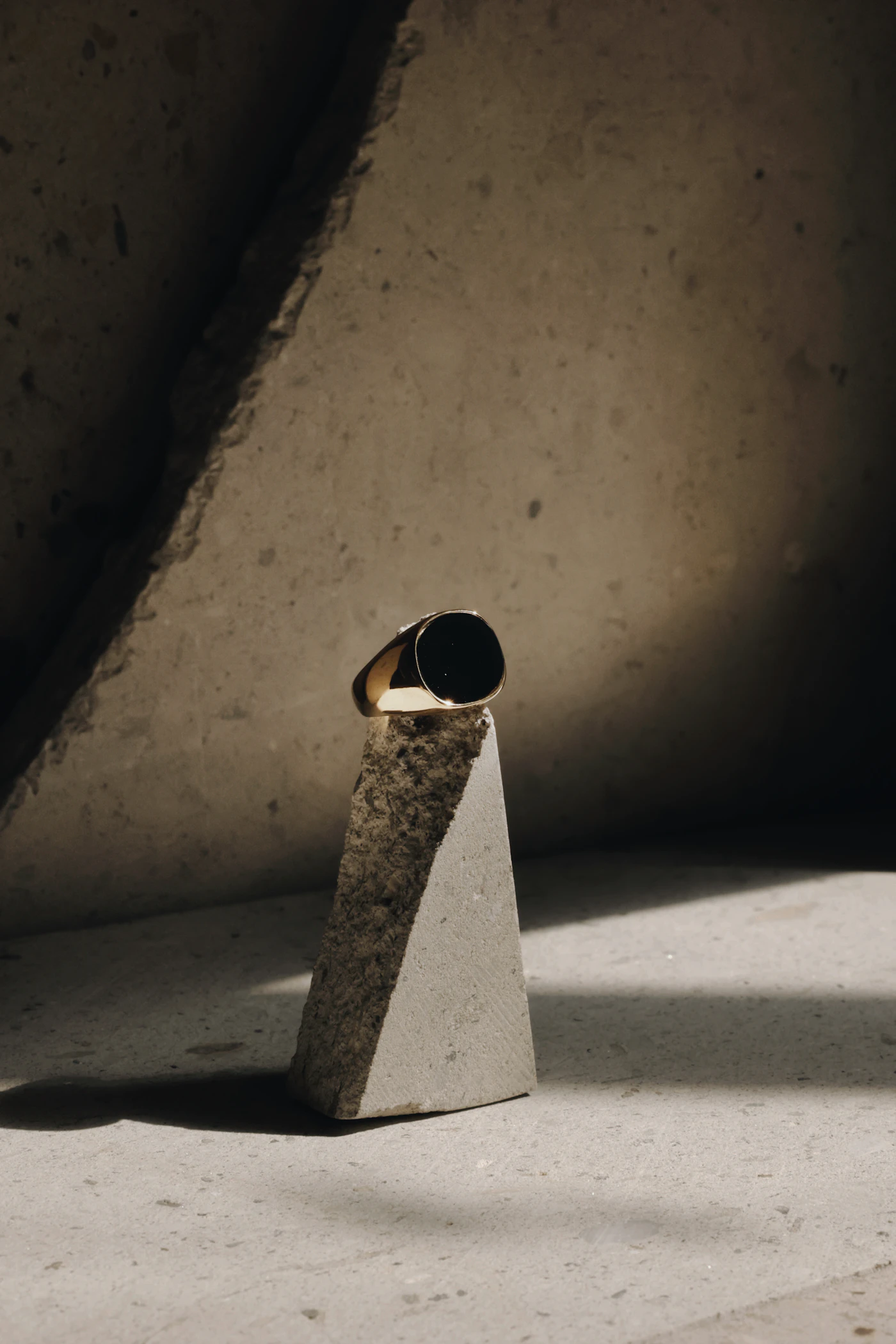 Black stone statement ring photographed on concrete